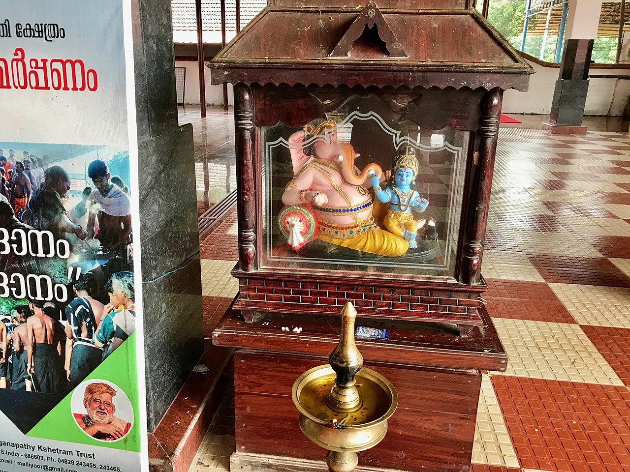 File:Baby Krishna on Ganapathy (Ganesha) lap in Malliyoor Maha ...