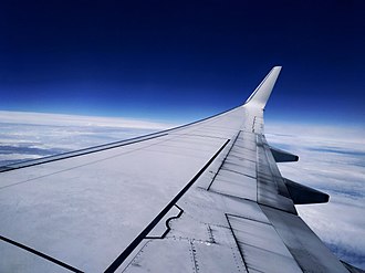 A Boeing 737-800 cruising in the stratosphere, where airliners typically cruise to avoid turbulence rampant in the troposphere. The blue layer is the ozone layer, fading further to the mesosphere. The ozone heats the stratosphere, making conditions stable. The stratosphere is also the altitude limit of jet aircraft and weather balloons, as the air density there is roughly
.mw-parser-output .frac{white-space:nowrap}.mw-parser-output .frac .num,.mw-parser-output .frac .den{font-size:80%;line-height:0;vertical-align:super}.mw-parser-output .frac .den{vertical-align:sub}.mw-parser-output .sr-only{border:0;clip:rect(0,0,0,0);clip-path:polygon(0px 0px,0px 0px,0px 0px);height:1px;margin:-1px;overflow:hidden;padding:0;position:absolute;width:1px}
1/1000 of that in the troposphere. Boeing 737 view 1.jpg