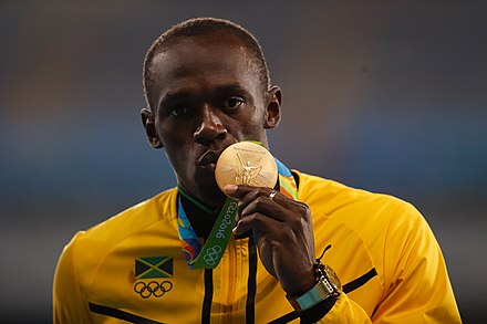 Bolt poses with his 200 m gold medal at the 2016 Summer Olympics