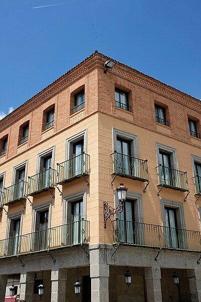 File:Brick and stone building in Spain with metal balconies.jpg