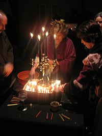 Neopagans honoring the dead as part of a Samhain ritual Candelabra and Grave Dirt (58205188).jpg