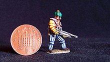 Miniature figure painted by Duncan Probert. The figure is slightly taller than an English penny and is in the style of a starship trouper on patrol.