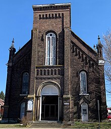 A brick church building, pictured from the front.