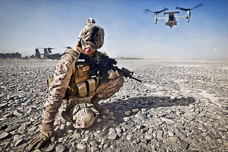 File:Defense.gov News Photo 111230-M-PH073-126 - U.S. Marine Corps Cpl. William Cox shields himself from flying rocks and sand as an MV-22 Osprey aircraft prepares to take off in Nimroz province.jpg