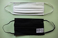 Cloth face masks certified by AFNOR. The white mask is made of polypropylene and the black one is made of cotton. Deux masques grand public.jpg