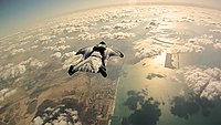 A wingsuit flyer over Palm Islands, Dubai Dubai Wingsuit Flying Trip (7623578306).jpg