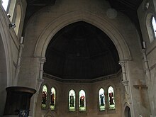 Stained-glass windows of 1905 by Morris & Co. in the former Emmanuel URC building, depicting Puritans with Cambridge connections. From left to right: Henry Barrow, John Greenwood, Oliver Cromwell, John Milton, Francis Holcroft and Joseph Hussey Emmanuel United Reformed Church interior, Cambridge.jpg