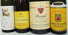 Four Vendange Tardive wines from different Alsace producers. Note that the two labels on the left use the plural form, Vendanges Tardives, while the two on the right use the singular form. Four Alsace Vendage Tardive bottles.jpg