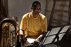 A tuba player taking notes in the Asociacion Rosalia de Castro. Havana (La Habana), Cuba