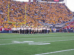 The drumline and sousaphone sections prepare for the pregame show. Hawkeye Marching Band, University of Iowa.jpg