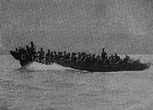 In 1941 a Marine Corps officer showed Higgins a picture of the Imperial Japanese Army practicing landings with the Daihatsu landing craft in 1935, a landing craft with a ramp in the bow, and Higgins was asked to incorporate this design into his Eureka boat. He did so, producing the basic design for the Landing Craft, Vehicle, Personnel (LCVP), often simply called the Higgins boat. IJA-ship-pioneers-with-Daihatsu-landing-craft.jpg