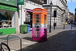 One of many Pride phone boxes painted by KCOM in Kingston upon Hull, this being painted in the colours of the Lesbian Pride flag.