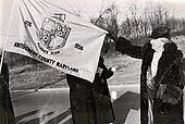 The first Montgomery County flag with its designer Lilly Catherine Stone in 1944. Lilly Catherine Stone with first Montgomery County flag, 1944.jpg