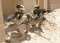 Two Marines in Afghanistan; the one in front carries a M16A4; the one in the rear is armed with a SAM-R.