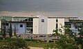 The NW facade of the building as viewed from the railway, over Railway Straight and Brooklands Drive 2 July 2011