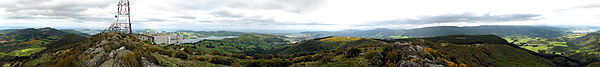 This is a panorama of the view from the summit of Mount Cargill. The base of a television mast can be seen on the left, with the Otago Harbour and the