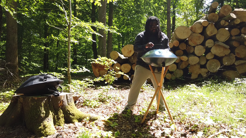 File:Musician playing handpan in the forest.png