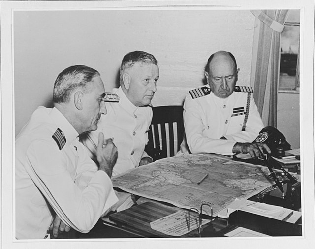 Kimmel (center) confers with his chief of staff, William "Poco" Smith; and operations officer and assistant chief of staff, Captain Walter S. DeLany (