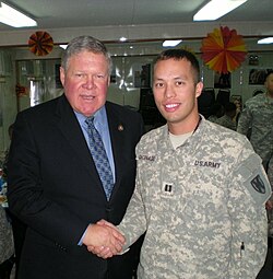 US Congressman Norm Dicks greets a US Army Soldier from Washington's 6th District at Camp Arifjan, Kuwait in 2010. Norman Dicks with Soldier.jpg