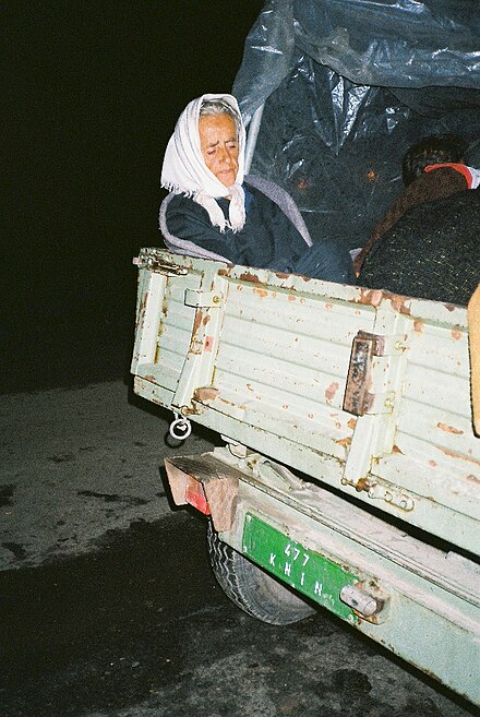 An elderly Serb refugee in a tractor trailer, after crossing the Yugoslav border
