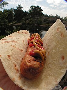 A typical Norwegian hot dog: sausage in a lompe, with ketchup and mustard Polse med lompe.jpg