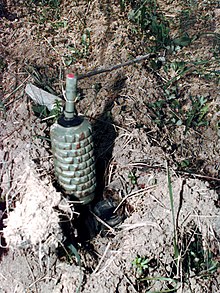 A Yugoslav POMZ anti-personnel mine that has been booby trapped with a hand grenade. A deminer could disable the stake mine, only to set off the hand-grenade when they remove the mine for disposal. (Balkans 1996) PMR-2A.JPEG
