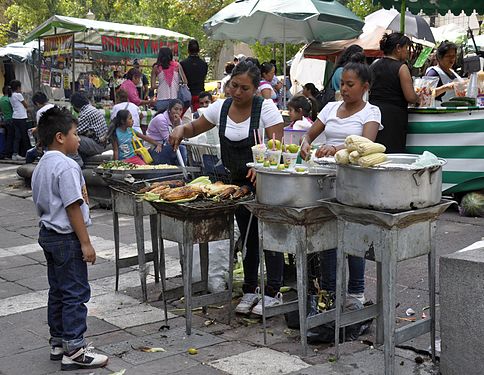 Grilled corn street food stand at Plaza Solidaridad Market near Alameda Central park in central Mexico City.