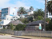 "Red Roost" and "Red Rest", two bungalow cottages built in 1894 on the road above La Jolla Cove. In recent years the cottages have been covered in tarpaulins. Red Roost, Red Rest, La Jolla.JPG