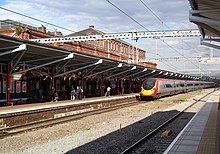 A Virgin Trains Pendolino calls at Rugby.