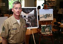 Sgt. Battles stands in front of some of his paintings. SgtKJBattles USMC 2010.jpg