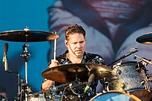 Jonny Quinn (pictured in 2018) joined as the band's drummer in 1997. Snow Patrol - 2018153203947 2018-06-02 Rock am Ring - 1D X MK II - 1116 - AK8I5316.jpg