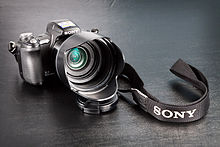 Sony Cyber-shot DSC-H50 bridge camera with lens hood attached. Sony DSC-H50 front with lens hood.jpg