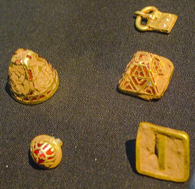 Assorted uncleaned gold fittings, three with cloisonné gold and garnet.