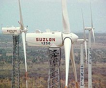 Wind generators of TNPL (extreme right) at Devarkulam, Tirunelveli, Tamil Nadu, India. TNPL windmill1.jpg