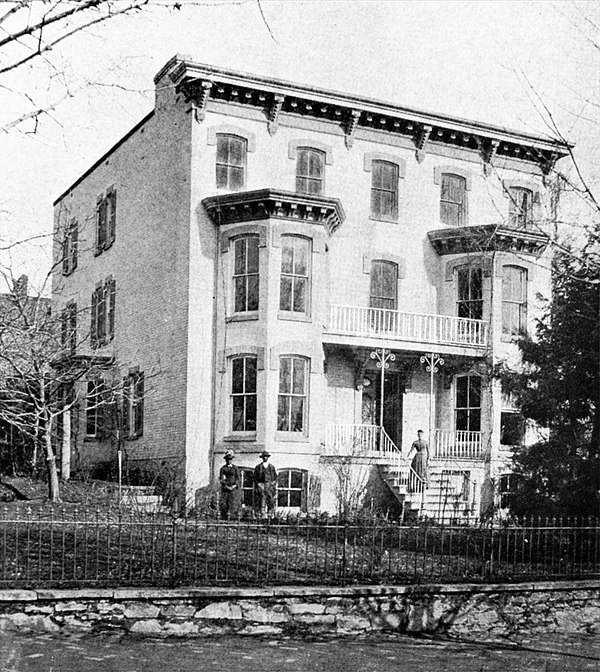 Hall's former home in the Georgetown neighborhood of Washington, D.C., after enlargement. Note Angeline on front steps and two workers.