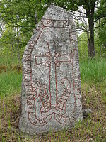 Rune stone, Sweden. With traditional gärdesgård fence in the