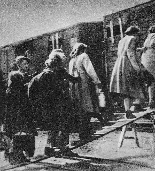 Jews forcibly displaced by the Nazi regime during Germany's WWII occupation of Poland, loaded onto trains for transport to concentration camps.