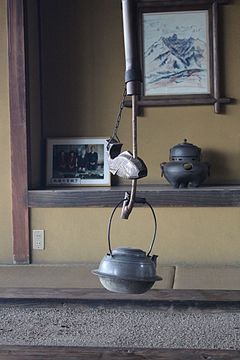 A jizaikagi hearth hook with fish-shaped counterbalance
