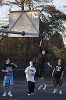 Asian young teenagers playing basketball in the afternoon, Auckland, New Zealand