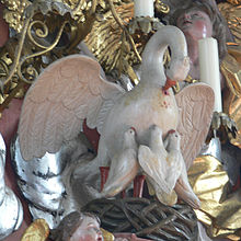 Statue of pelican wounding its breast to feed its chicks Bergatreute Pfarrkirche Hochaltar Vogelnest.jpg