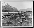 Bird's-eye view of Eddy, Montana, showing buildings, railroad tracks along river, and snow-capped mountains in background LCCN98519298.jpg