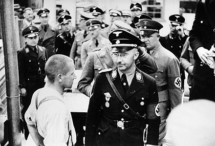 Heinrich Himmler (front right, beside prisoner) inspecting Dachau Concentration Camp on 8 May 1936.