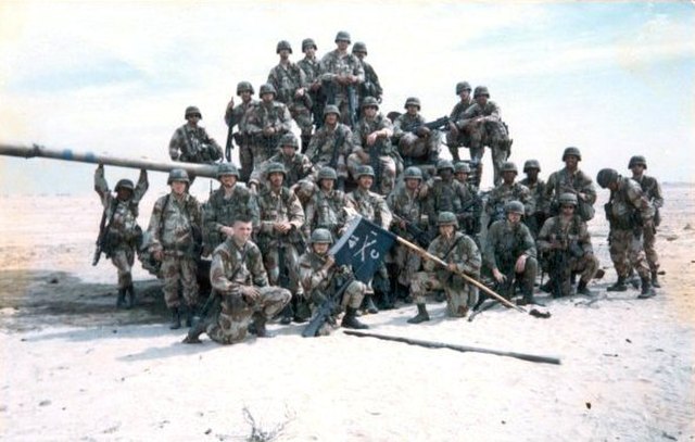 Soldiers of 2nd Platoon, Company C, 1st Battalion, 41st Infantry Regiment pose with a captured Iraqi tank during the 1st Gulf War, February 1991.