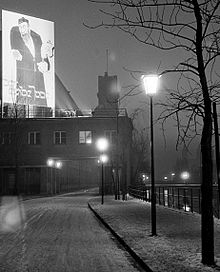 The huge poster was illuminated at night so that passers-by would even notice it from the across the Isar river, view from Uferstrasse, of the Deutsches Museum library building, Munich, 1937. Deutsches Museum - Plakat der ewige Jude, 1937.jpg