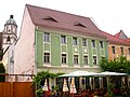 Residential house in closed development with side wing in the courtyard