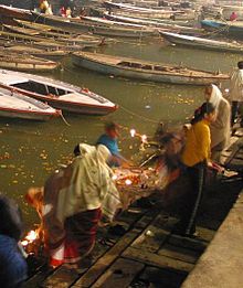 Hindus putting lit oil lamps on the river Ganges. Ganges ceremony candles.jpg