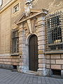 Portal of a palace on Via Garibaldi. The street, a symbol of the prosperity achieved by the city in the Century of the Genoese (El siglo de los Genoveses), was restored for the 2001 G8 and Genoa Capital of Culture 2004; the buildings house the headquarters of the City Council, several museums and the headquarters of some banks.