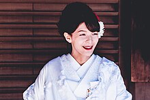 A Kimono-clad woman Kimono-clad woman with flowers in hair (Unsplash).jpg