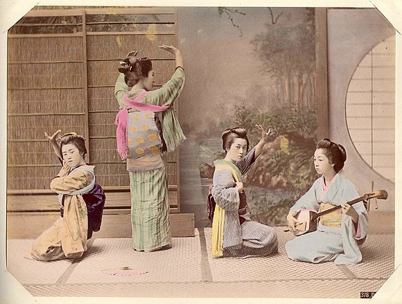 An early photograph of Japanese women in dance pose.