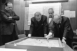 U.S. President Lyndon Johnson and aides examining a model of a U.S. position in South Vietnam. L B Johnson Model Khe Sanh.jpeg